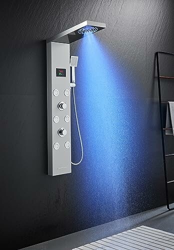 Modern shower panel with digital controls and LED lighting.