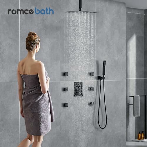 Woman in a towel standing in a modern shower.