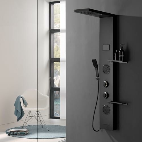 Minimalist bathroom with a black shower panel and a white chair by the window.