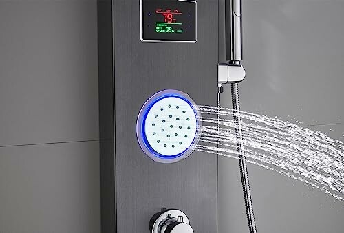 Modern shower panel with digital display and handheld showerhead.